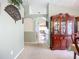 Hallway with archway, decorative wall art, and built-in china cabinet for a welcoming and stylish entry at 12322 Hawkeye Point Pl, Riverview, FL 33578