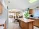 Bright kitchen leading to living room, featuring an island and adjacent dining area perfect for entertaining at 12322 Hawkeye Point Pl, Riverview, FL 33578