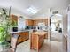 Charming kitchen with wood cabinetry, a center island, and an open layout leading to living spaces at 12322 Hawkeye Point Pl, Riverview, FL 33578