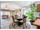 Bright eat in kitchen with center island, leading into living room and natural light at 12322 Hawkeye Point Pl, Riverview, FL 33578