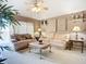 Bright living room with plush sofas, elegant decor, and plenty of space for relaxation and entertaining at 12322 Hawkeye Point Pl, Riverview, FL 33578