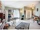 Well-lit living room featuring a mix of modern and classic elements, ideal for a home office setup at 12322 Hawkeye Point Pl, Riverview, FL 33578