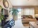 Living room featuring a TV, sliding doors to the back, and neutral decor creating a relaxing and inviting space at 12322 Hawkeye Point Pl, Riverview, FL 33578