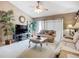 Inviting living room with a ceiling fan, plush sofa, and neutral decor offering a cozy place to relax at 12322 Hawkeye Point Pl, Riverview, FL 33578