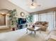 Comfortable living room features a ceiling fan, plush sofa, and neutral decor creating a cozy atmosphere at 12322 Hawkeye Point Pl, Riverview, FL 33578