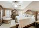 Spacious main bedroom with a luxurious bed, elegant furnishings, and a serene ambiance for restful nights at 12322 Hawkeye Point Pl, Riverview, FL 33578