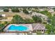 Aerial view of the community pool, clubhouse, playground and surrounding homes at 12322 Hawkeye Point Pl, Riverview, FL 33578