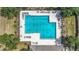 Aerial shot of large community pool surrounded by deck chairs and lush landscaping at 12322 Hawkeye Point Pl, Riverview, FL 33578