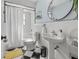 Bathroom featuring tiled floors, updated pedestal sink, shower/tub combination with a white shower curtain at 12384 144Th St, Largo, FL 33774