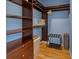 Walk-in closet with custom wooden shelving, drawers, and hanging rods, offering ample storage space at 12384 144Th St, Largo, FL 33774