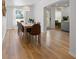 Bright dining room with hardwood floors, a modern light fixture, large windows, and seating for ten people at 12384 144Th St, Largo, FL 33774