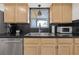 Close up of the kitchen sink and stainless steel appliances with ample counter space and natural wood cabinets at 12384 144Th St, Largo, FL 33774