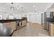 Modern kitchen featuring stainless steel appliances and a breakfast bar overlooking the living area at 12384 144Th St, Largo, FL 33774