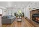 Spacious living room featuring wood floors, natural light and stone fireplace at 12384 144Th St, Largo, FL 33774