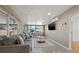 Bright living room with large windows, gray sofa, and a modern circular coffee table with stylish rug at 12384 144Th St, Largo, FL 33774