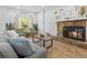 Cozy living room featuring a stone fireplace, wood floors, and neutral decor at 12384 144Th St, Largo, FL 33774