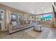Bright living room with large windows, gray sofas, a modern coffee table, and stylish rug at 12384 144Th St, Largo, FL 33774