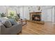 Comfortable living room with stone fireplace, large window and neutral decor at 12384 144Th St, Largo, FL 33774