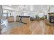 Open-concept kitchen and living area with stone fireplace and modern appliances at 12384 144Th St, Largo, FL 33774