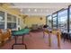 Spacious covered patio with poker table, foosball table, and seating areas for entertaining guests at 12384 144Th St, Largo, FL 33774