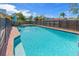 Sparkling pool featuring a secure fence and a surrounding concrete patio for lounging at 12384 144Th St, Largo, FL 33774