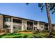 Well-maintained condo building with lush green lawn and mature landscaping enhancing curb appeal at 124 Nina Way # 24, Oldsmar, FL 34677