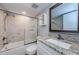 Well-lit bathroom features a shower-tub combo and gray granite vanity at 124 Nina Way # 24, Oldsmar, FL 34677