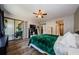 Bright bedroom with ceiling fan, wood flooring, and sliding glass doors at 124 Nina Way # 24, Oldsmar, FL 34677
