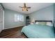 Bedroom with light blue walls, ceiling fan, and light-filled window at 124 Nina Way # 24, Oldsmar, FL 34677
