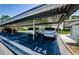 Assigned covered parking area with clearly marked parking spaces provides protection from the elements at 124 Nina Way # 24, Oldsmar, FL 34677