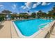 Community pool with lounge chairs offers a relaxing oasis for residents at 124 Nina Way # 24, Oldsmar, FL 34677