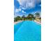 Community pool with lounge chairs offers a relaxing oasis for residents at 124 Nina Way # 24, Oldsmar, FL 34677