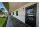 Hallway exterior featuring a black door. The building shows windows, doors and an inviting outdoor space at 124 Nina Way # 24, Oldsmar, FL 34677