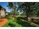 Lush green lawn and mature trees surrounding condo building create a tranquil and inviting environment at 124 Nina Way # 24, Oldsmar, FL 34677