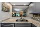 Open kitchen view with granite countertops and gray cabinets at 124 Nina Way # 24, Oldsmar, FL 34677