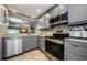 Beautiful kitchen featuring gray cabinets, stainless steel appliances, and granite countertops at 124 Nina Way # 24, Oldsmar, FL 34677