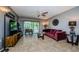 The living room features a ceiling fan and porch access creating a comfortable and seamless indoor-outdoor flow at 124 Nina Way # 24, Oldsmar, FL 34677