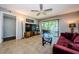 Living room with ceiling fan and sliding glass doors to the porch. The space has tile floors and ample natural light at 124 Nina Way # 24, Oldsmar, FL 34677