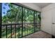 Enclosed patio with a view of the street with trees at 124 Nina Way # 24, Oldsmar, FL 34677