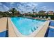 Sparkling community pool area with lounge chairs and lush landscaping at 124 Nina Way # 24, Oldsmar, FL 34677