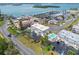 Aerial view of the complex highlighting the landscaped grounds, community pool, and water views at 12485 2Nd E St # C103, Treasure Island, FL 33706