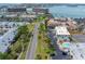 Aerial view showing the community's layout, landscaping, pool, and nearby coastal location at 12485 2Nd E St # C103, Treasure Island, FL 33706