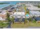 Community aerial view showcasing lush landscaping, community pool, and proximity to the water at 12485 2Nd E St # C103, Treasure Island, FL 33706