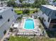 Aerial view of a community pool surrounded by well-maintained lawns and landscaping offering relaxation and recreation at 12485 2Nd E St # C103, Treasure Island, FL 33706