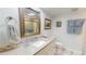 Bright bathroom featuring a vanity with a sink, framed mirror and shower at 12485 2Nd E St # C103, Treasure Island, FL 33706