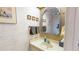 Cozy bathroom with decorative wallpaper and a vanity at 12485 2Nd E St # C103, Treasure Island, FL 33706