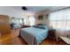 Well-lit bedroom with hard floors, large mirrored closet and a ceiling fan at 12485 2Nd E St # C103, Treasure Island, FL 33706