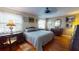Charming bedroom featuring hard floors, a ceiling fan, and antique-style furniture at 12485 2Nd E St # C103, Treasure Island, FL 33706