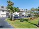 Charming townhome featuring a private garage, lush landscaping, and ample parking spaces at 12485 2Nd E St # C103, Treasure Island, FL 33706