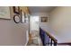 Upper hallway features hardwood floors, multiple wall-mounted decorations, and a wood railing at 12485 2Nd E St # C103, Treasure Island, FL 33706
